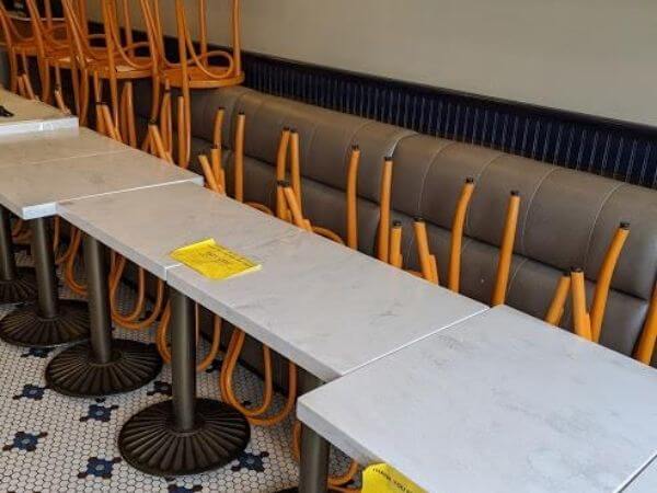 Empty banquettes inside a Campbell, CA dining establishment