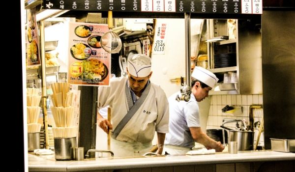 Cooks working in restaurant kitchen